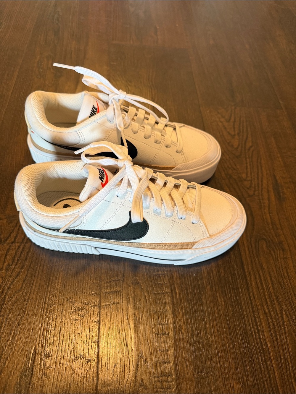 Nike White Low-Top Sneakers with Black Swoosh
